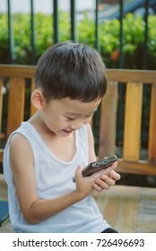 Portrait Of Asian Boy Use Smartphone Talk With Mom, FaceTime, Miss Mom Concept.