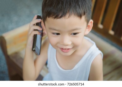 Portrait Of Asian Boy Use Smartphone Talk With Mom, FaceTime, Miss Mom Concept.