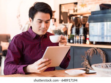 Portrait Of Asian Business Man Reading Message With Tablet Coffee Shop