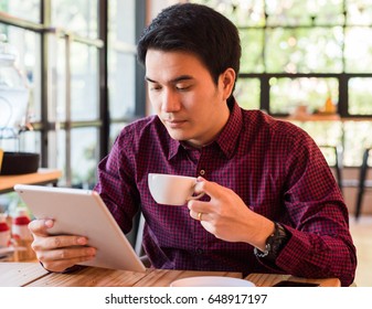 Portrait Of Asian Business Man Reading Message With Tablet Coffee Shop