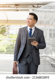 Portrait Asian Business Man Business Walking On Business District ,senior Visionary Executives Leader With Business Vision , Tabled Phone Computer In Hand