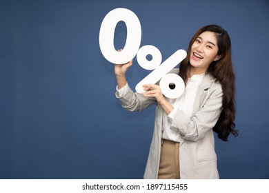 Portrait of Asian business woman showing and holding 0% number or zero percent isolated over deep blue background