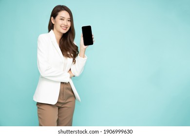 Portrait of Asian business woman showing or presenting smartphone or mobile phone application isolated over green background, Asian Thai model - Powered by Shutterstock