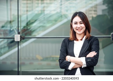 Portrait Of Asian Business Woman Smiling And Embrace Outdoor Of Her Office Or Airport