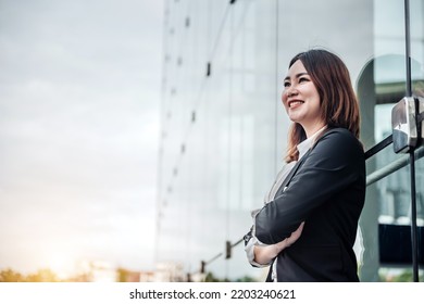 Portrait Of Asian Business Woman Smiling And Embrace Outdoor Of Her Office Or Airport