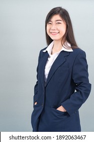 Portrait Of Asian Business Woman Standing Isolated On Gray Background