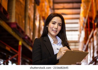 Portrait Of Asian Business Woman Or Vice President Smiling And Holding Clipboard At Warehouse Factory. Confidence People With Positive Vision Working At Import Export Company Concept With Copy Space