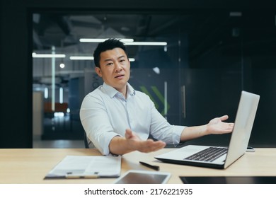 Portrait Of Asian Businessman Man, Disappointedly Spreading Hands And Looking At Camera, Korean Owner Manager Working In Modern Office, Not Satisfied With Work Result.