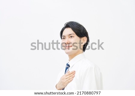 Portrait of Asian businessman OK gesture in white background