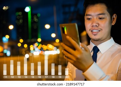 Portrait Asian Businessman Typing An Sms Message Via Smartphone After Work Near Office At Night City Street, Bokeh Lights, Young Man Walking And Chatting With Friends At Social Networks Outdoor