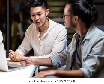 Portrait Of Asian Businessman Working Late Having Meeting With Business Team To Brainstorm Idea At Office Meeting Room. Work Hard Deadline And Overtime Working And New Business Start Up Concept.