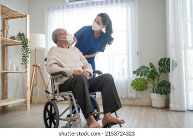 Portrait Of Asian Caregiver Nurse Take Care Senior Male On Wheelchair. Attractive Specialist Carer Women Wear Face Mask, Support Elderly Grandfather At Nursing Home Care And Smile, Look At Each Other.