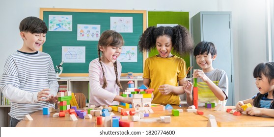 Portrait of asian caucasian little children playing blocks in classroom. Learning by playing education group study concept. International pupils doing activities brain training in primary school.  - Powered by Shutterstock