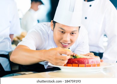 Portrait Of Asian Chef Decorating Cake