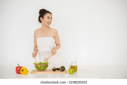 Portrait Of Asian Chef Girl Cooking Vegetable Salad Juice In Kitchen Home. New Normal Work At Home Lifestyle. Healthy Food Eco Friendly Homemade Meal, Happy Do It Yourself Asian Housewife Concept