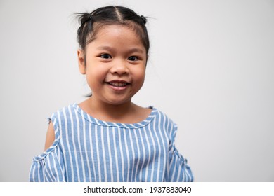 Portrait Of Asian Child 5 Year Old And To Collect Hair And A Big Smile On Isolated White Background, She Is Happiness, Radiance In Youth