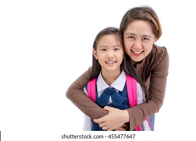Portrait of asian child in school uniform hugging with mother on white background isolated