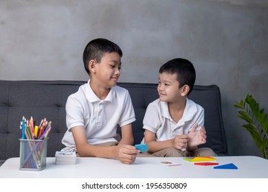 Portrait of asian children playing colorful blocks, Learning by playing education home school concept, kids playing with puzzle doing tangram, education concept, Two kids playing with blocks games.