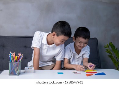 Portrait of asian children playing colorful blocks, Learning by playing education home school concept, kids playing with puzzle doing tangram, education concept, Two kids playing with blocks games.