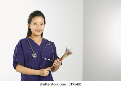 Portrait Of Asian Chinese Mid-adult Female Doctor Smiling And Looking At Viewer.