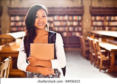 A portrait of an Asian college student in library