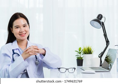 Portrait Asian Confident Female Doctor Working Personal Laptop Computer At Hospital Office. Thai Woman Medical Expertise Staff Smiling Sitting Posing On Desk Space Front Computer, Healthcare Concept