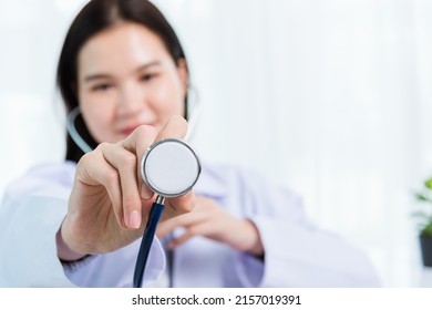 Portrait Asian Confident Female Doctor Working Personal Laptop Computer At The Hospital Office. Thai Woman Medical Expertise Staff Smiling Hand To Hold Show Stethoscope On Desk Space Front Computer