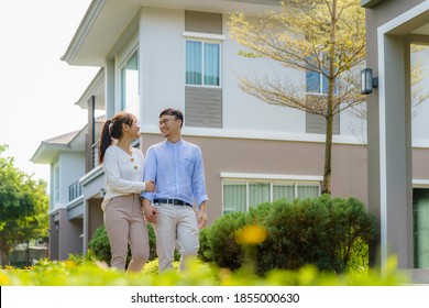 Portrait Of Asian Couple Walking And Hugging Together Looking Happy In Front Of Their New House To Start New Life. Family, Age, Home, Real Estate And People Concept.