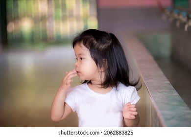 Portrait Of Asian Cute Girl Cleaning Her Face. Side View Of Child In The Kindergarten School. Refresh After Wakeup Afternoon.