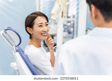 Portrait of an Asian dentist at the dentist - Powered by Shutterstock