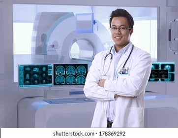 Portrait of asian doctor in MRI room at hospital, looking at camera, smiling.