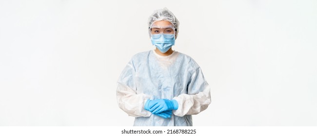 Portrait Of Asian Doctor Or Nurse In Ppe, Personal Protective Equipment, Standing In Confident, Ready Pose, White Background