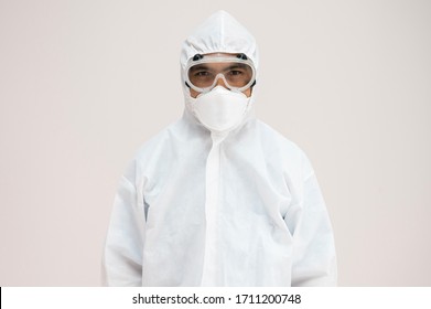 Portrait Asian Doctor In Protective PPE Suit Wearing Face Mask And Eyeglasses For Protect Coronavirus Covid-19 Virus.Scientist Male Wearing Personal Protection Equipment Making Laboratory In Hospital.