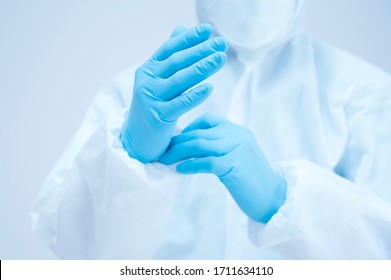 Portrait Asian Doctor In Protective PPE Suit Wearing Face Mask And Eyeglasses For Protect Coronavirus Covid-19 Virus.Scientist Male Wearing Personal Protection Equipment Making Laboratory In Hospital.