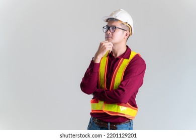 Portrait Of Asian Engineer Wearing Hardhat Posing Against In A Studio. Architect, Engineer, Civil Concept Of Construction. 