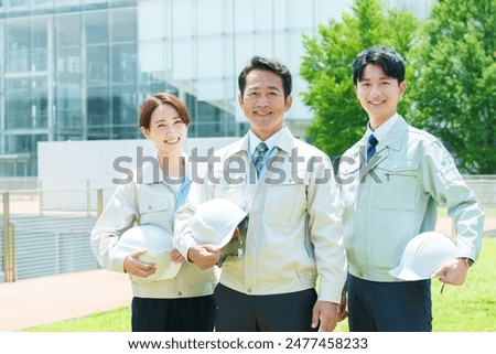 portrait of asian engineer in workwear standing in front of factory