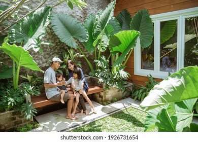 Portrait Of Asian Family Enjoy Their Time At Tropical Backyard At Home