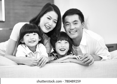 Portrait Of An Asian Family With Two Children, Happy And Smiling, Black And White.