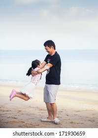 Portrait Of Asian Family Walking On The Beach