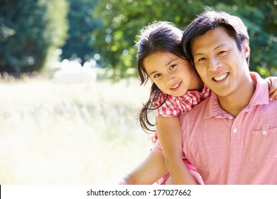 Portrait Of Asian Father And Daughter In Countryside