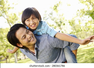 Portrait Asian Father And Son Playing In Park