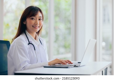 Portrait Of Asian Female Doctor Healthcare Professionals Smiling Working With Computer Laptop, Telehealth Medical Concept