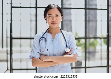 Portrait Of Asian Female Doctor Looking At Camera With Arms Crossed