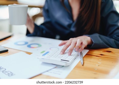 Portrait Of An Asian Female Employee Using A Calculator To Calculate Corporate Income Tax To Submit Evidence To The Revenue Department Before The End Of The Year.