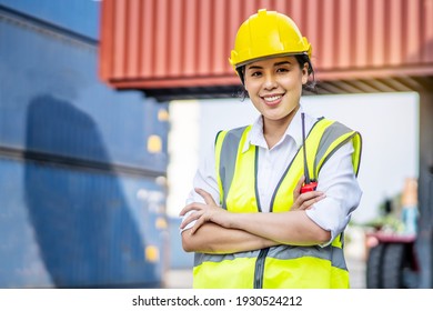 Portrait Of Asian Female Engineer Wearing Protection Standing Confidently Crossed Her Arms In The Cargo Area Of ​​the Ship Yard