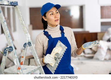 Portrait Of Asian Female House Painter With Tools In Renovated Room