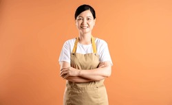 Portrait Of Asian Female Housewife Posing On Brown Background