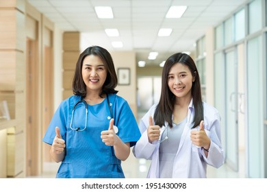 Portrait Of Asian Female Nurse Team In Hospital Corridor. Group Of Woman Doctors Wear Uniform In Hospital Corridor