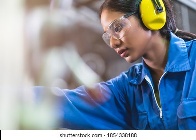 portrait asian female Professional engineering wearing uniform and safety goggles Quality control, maintenance, monitor screen checking process in factory, warehouse Workshop for factory operators - Powered by Shutterstock