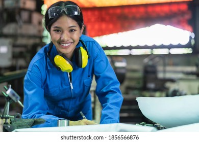 portrait asian female Professional engineering wearing uniform and safety goggles Quality control, maintenance, check in factory, warehouse Workshop for factory operators - Powered by Shutterstock